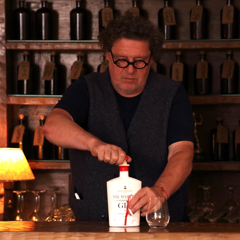 Marco Pierre White opening a bottle of Mr White’s London Dry Gin