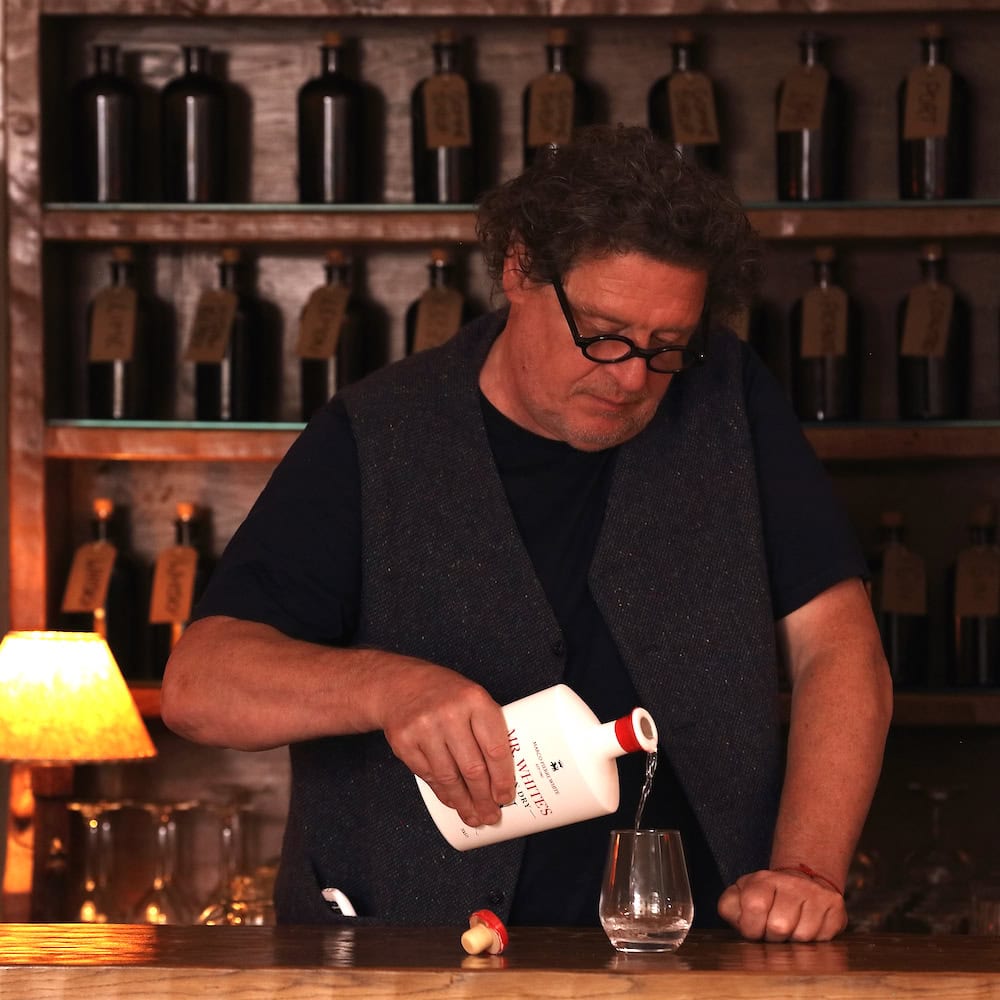 Marco Pierre White pouring Mr White’s London Dry Gin into a glass